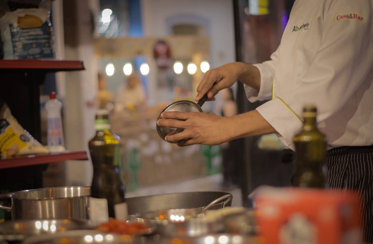 journey A chef carefully preparing a meal in a warmly lit, cozy restaurant kitchen setting.