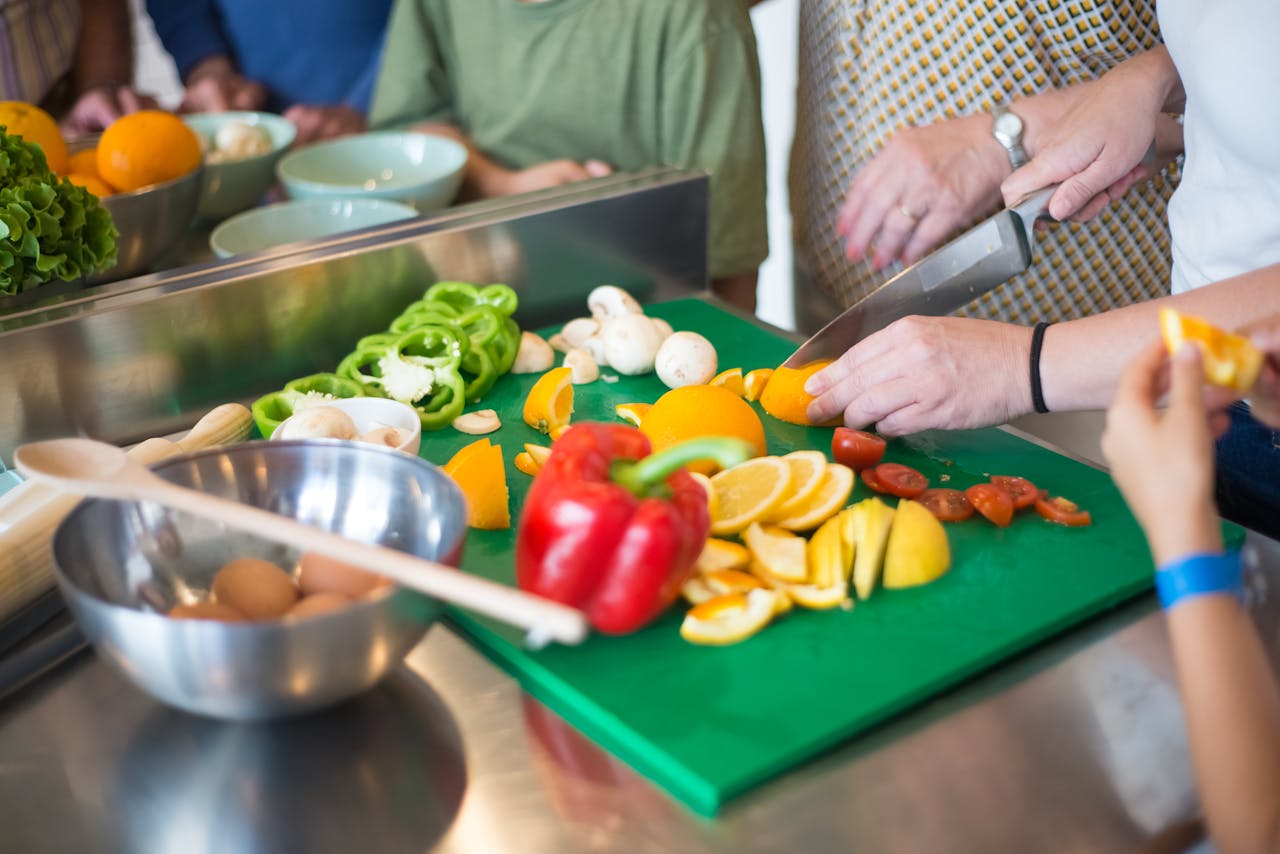 why-choose-us A family enjoying cooking together indoors with fresh fruits and vegetables.